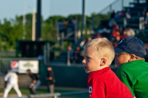 two young boys watching baseball game