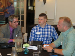 Jim Sieben, president of Nova Tech Engineering in Willmar, visited with Austin Swanson, a KCEO student, and his father, Curry Swanson, at the program’s orientation in July. Students from three Kandiyohi County school districts are participating in the first CEO program in Minnesota.