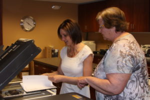 Ridgewater College student Kristine Karl, left, has been job shadowing at SWIF with Accounting Specialist Deb Berggren. Karl is helping update W-9 documentation and file the documents electronically.