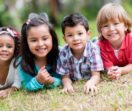 Children on the grass smiling