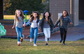 Group of happy kids running outside