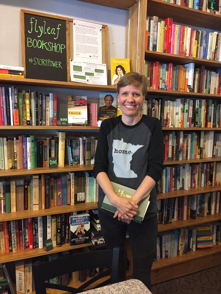 Book shop owner Heather King standing among shelves full of books