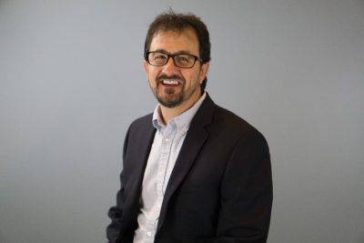 headshot of Jeff in front of a grey background