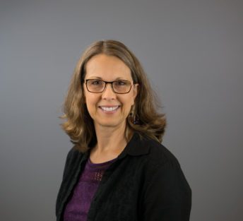 headshot of Judy in front of a grey background