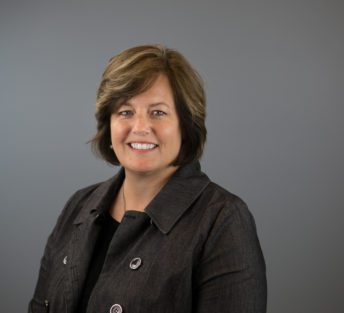 headshot of Amy in front of grey background