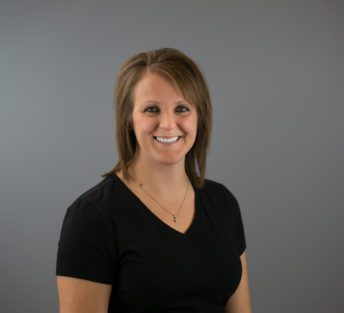 headshot of Jodi in front of a grey background