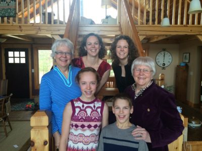 Renae SAunders poses on a staircase with her family