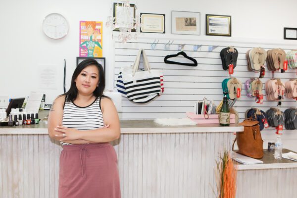 Nancy Beck stands at the front counter of her small business, Polish Nail Lounge in Marshall.