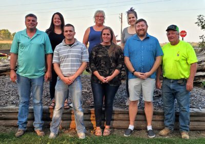 Lamberton Area Community Foundation board members stand shoulder-to-shoulder outdoors smiling for the camera