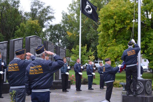 Dassel American Legion Post 364 members raise the American flag