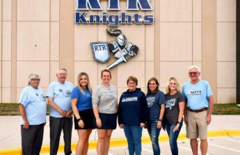 RTR Educational Foundation Advisory Board members stand in front of the school in spirit wear
