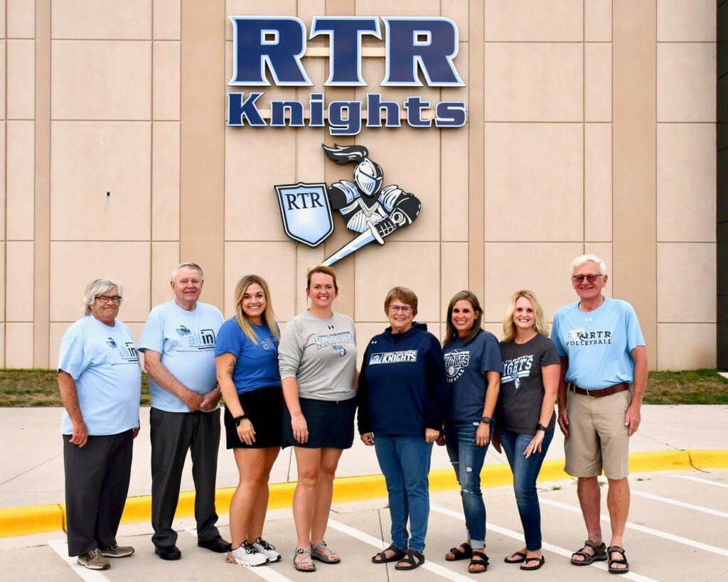 Educational foundation group standing in front of RTR Knights building