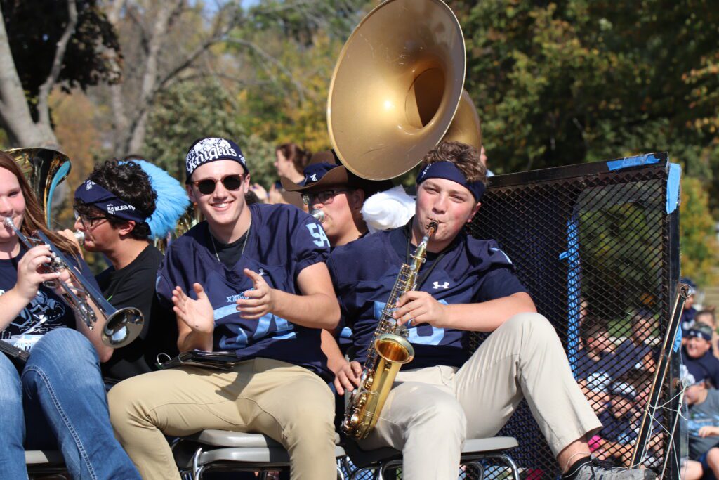 RTR Knights bandmates playing their instruments on a parade float