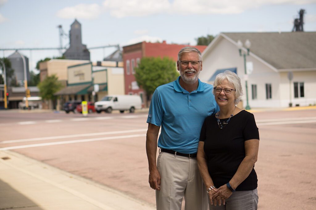 Saunders couple smiling while standing on main street