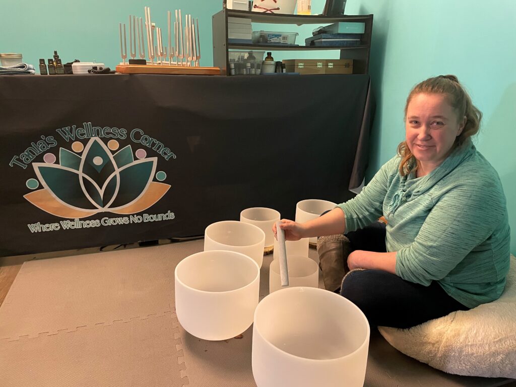 Tania sits in her office surrounded by singing bowls.