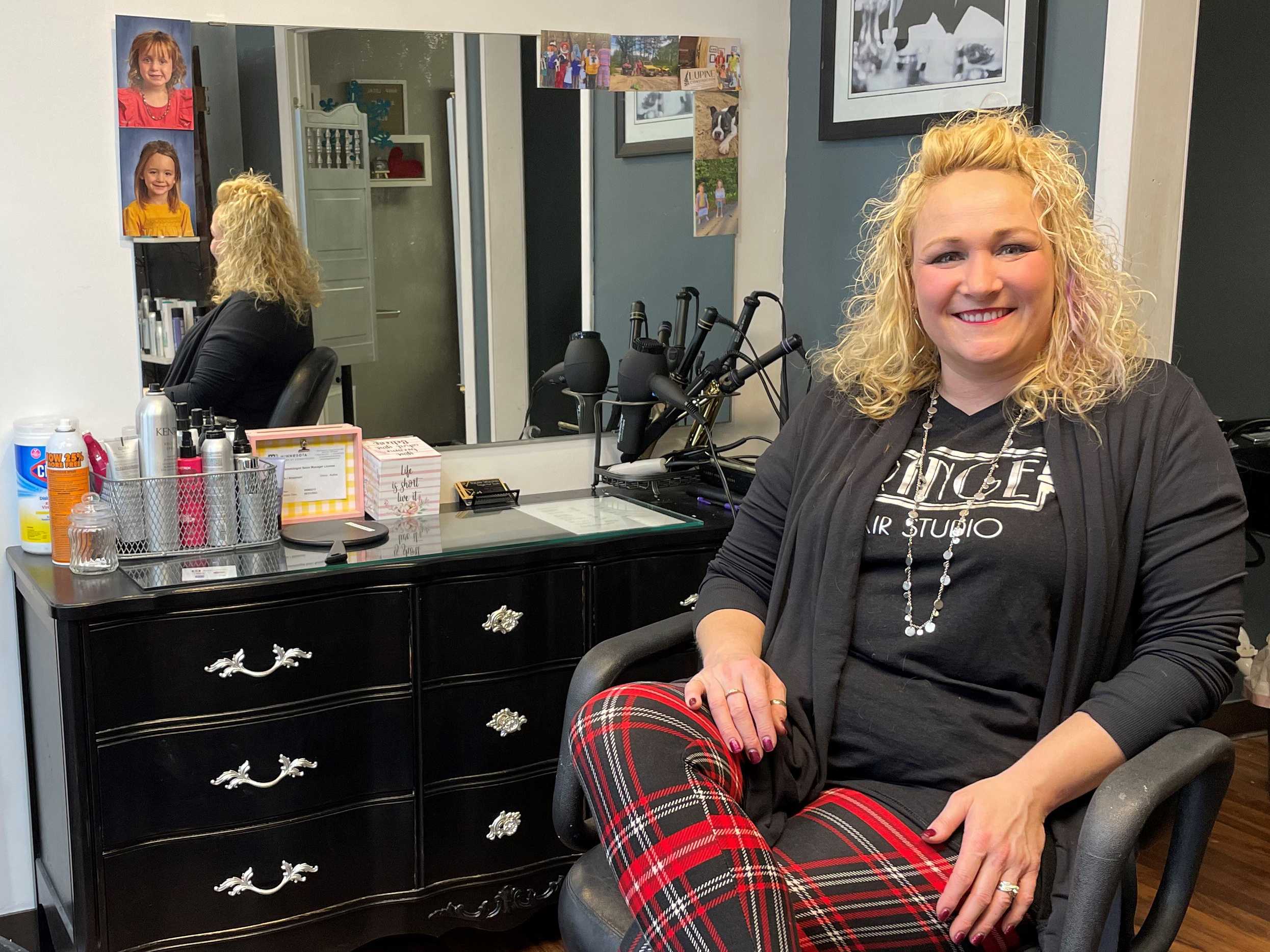 Tracee Strazzinski sitting in her chair at a hair salon