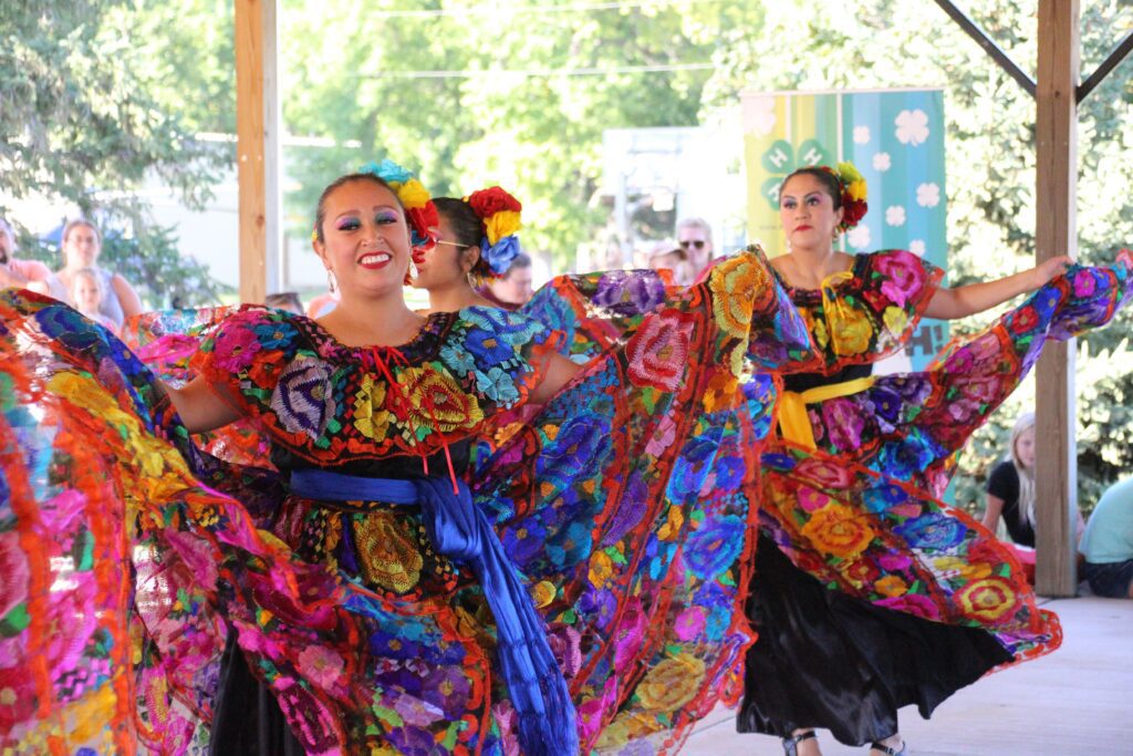 Dancers in vibrant dresses perform at KMS Welcoming Week