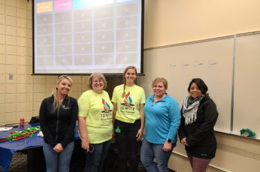 A group of SWIF coworkers pose for a group photo at the IGNITE career expo.