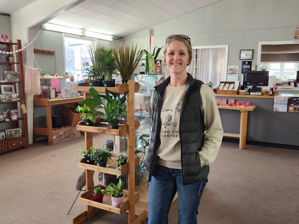 Nicole stands inside Olivia Floral, Gift and Garden Center's retail space.