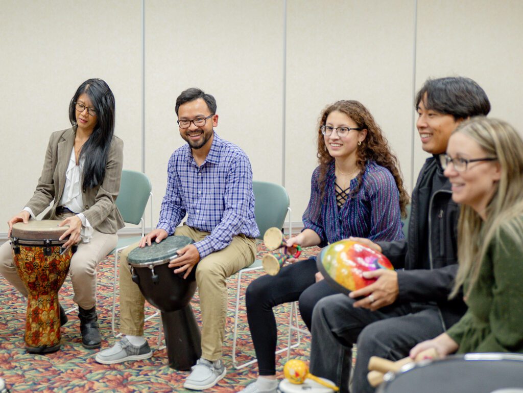group of 5 playing musical instruments
