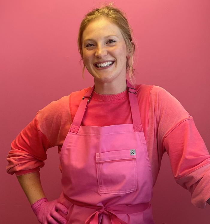 mackenzie dammann wearing a pink apron outfit