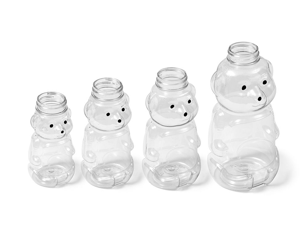 A group of plastic bottles shaped like bears arranged in ascending size order