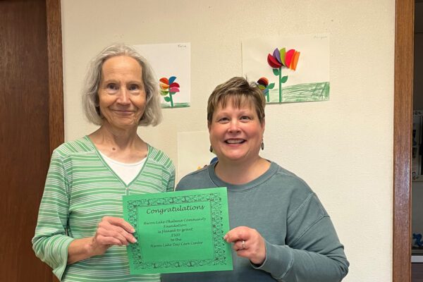 Kaye Fury (left) accepts a grant for the Heron Lake Day Care Center from the Heron Lake Okabena Community Foundation. Presenting the grant is local foundation board member Tracy Freking.