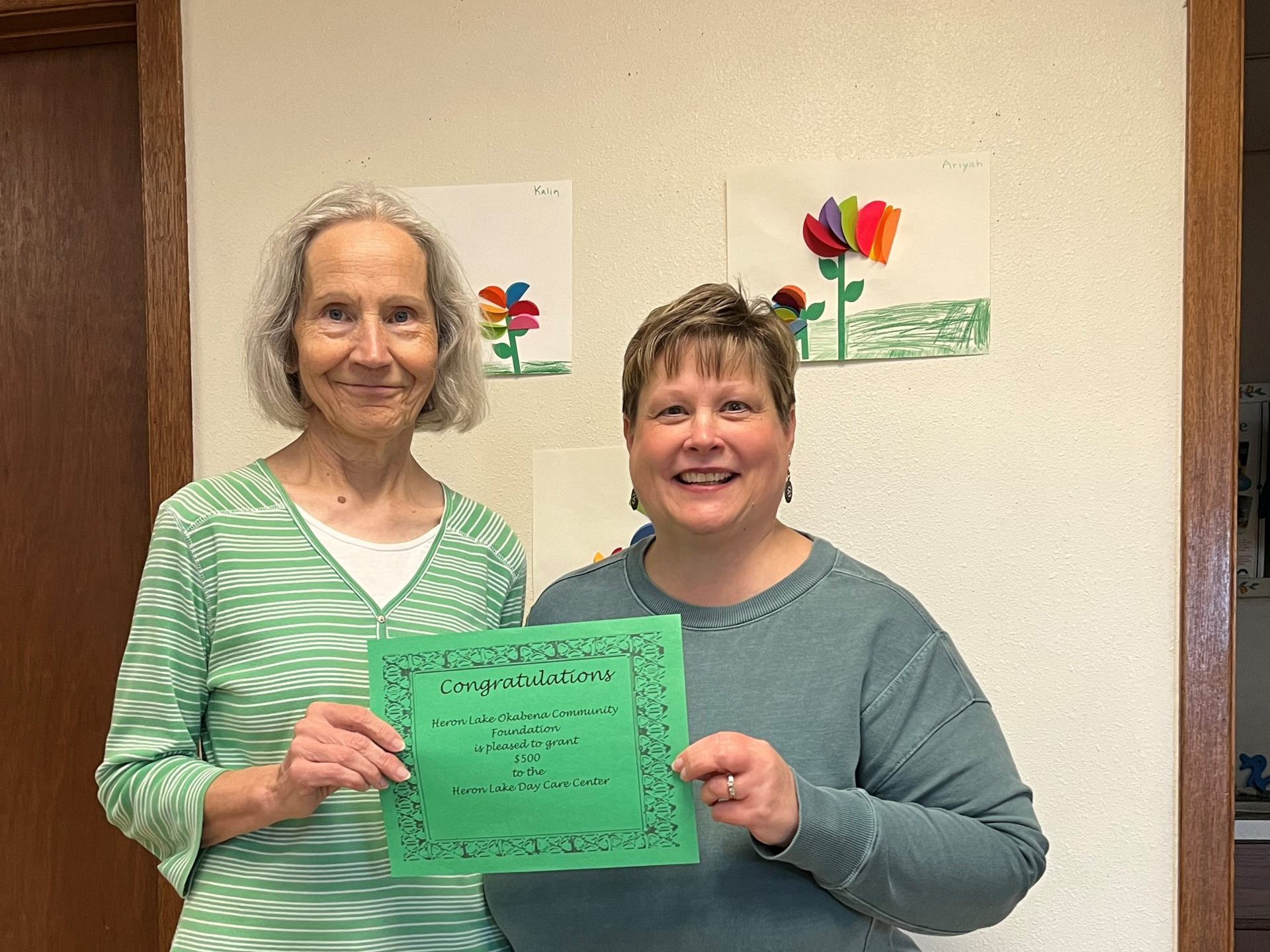 Kaye Fury (left) accepts a grant for the Heron Lake Day Care Center from the Heron Lake Okabena Community Foundation. Presenting the grant is local foundation board member Tracy Freking.