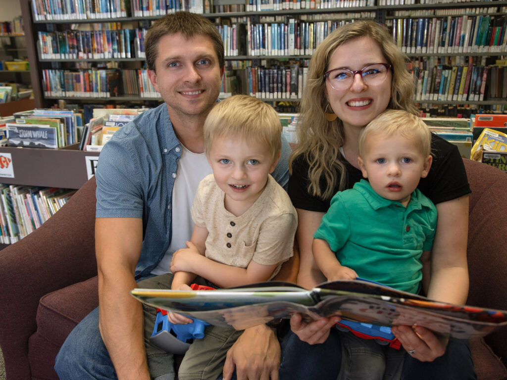 Charlie and Noah Zaske visit the Hutchinson Library with dad and mom, Mark and Ari.