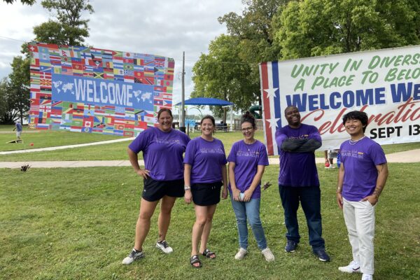 Volunteers pose for a group photo at an event for Welcoming Week in Litchfield.