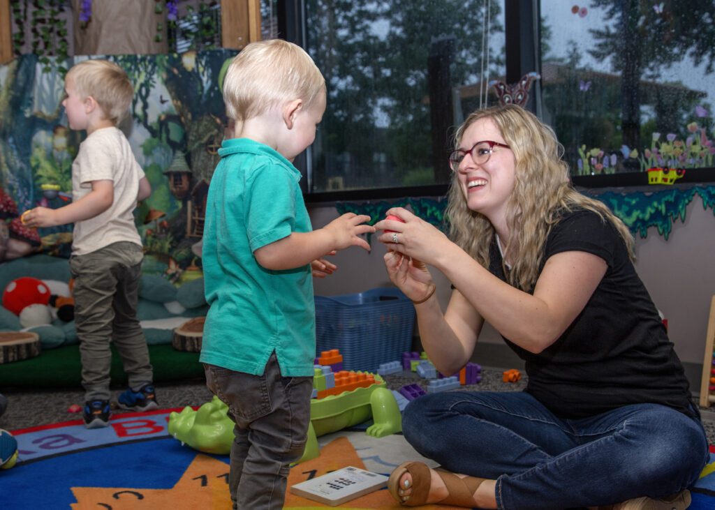 Ari and her young son play together in the children's section of the library.