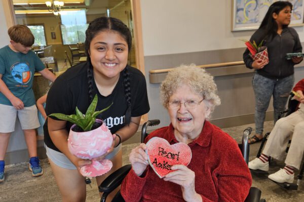 Perla and Pearl show off their art work.