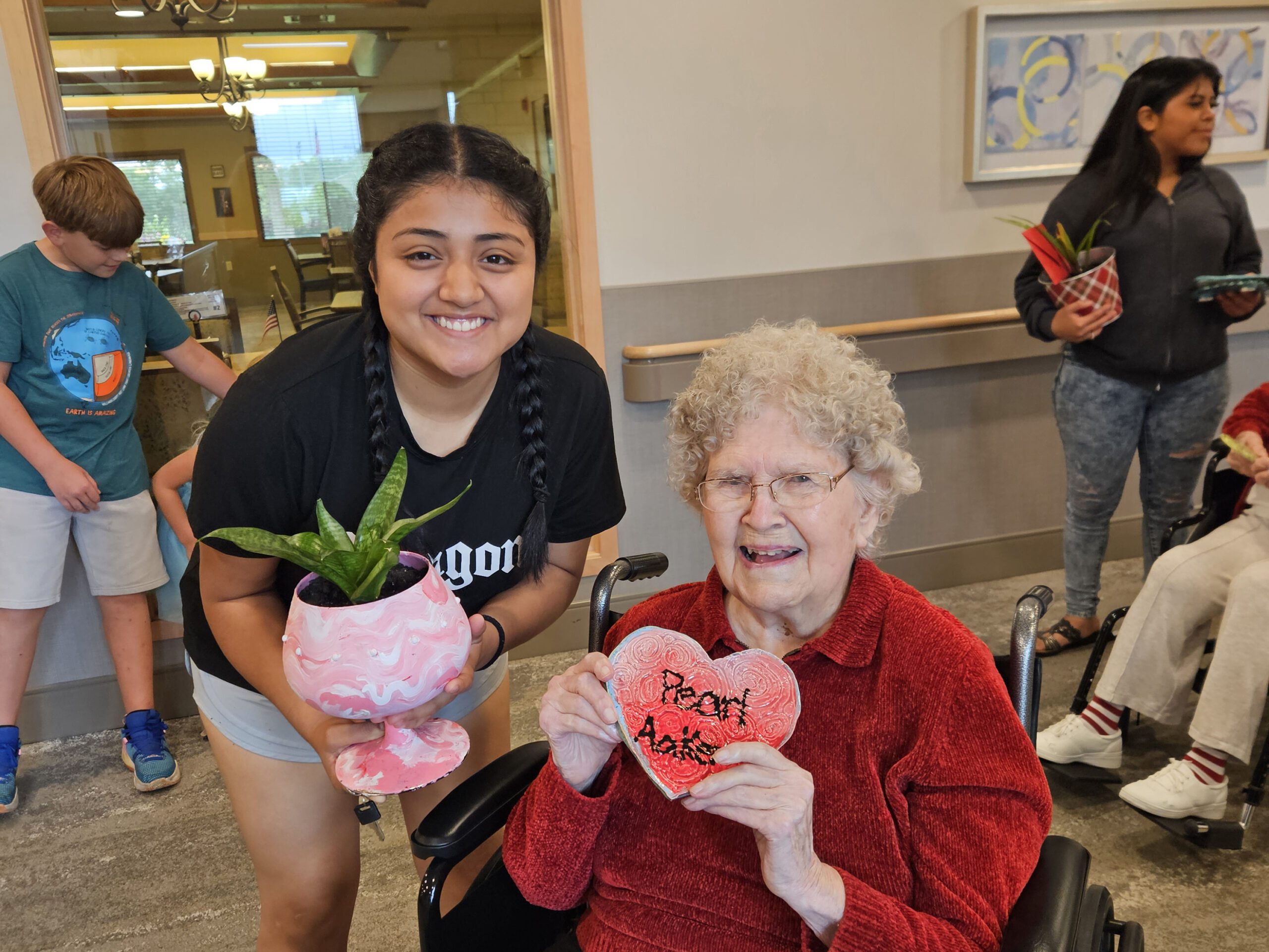 Perla and Pearl show off their art work.