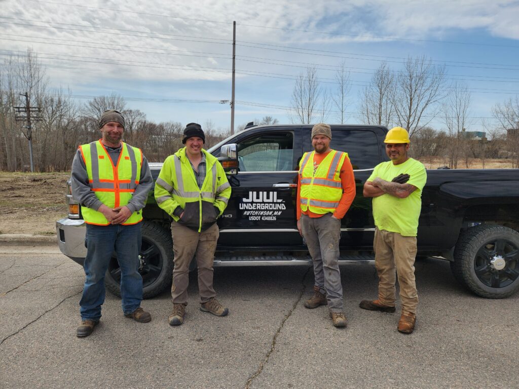 Small business owner Matt Yurek poses with his team and a pickup truck that has Juul Underground on the door.
