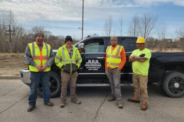 Small business owner Matt Yurek poses with his team and a pickup truck that has Juul Underground on the door.