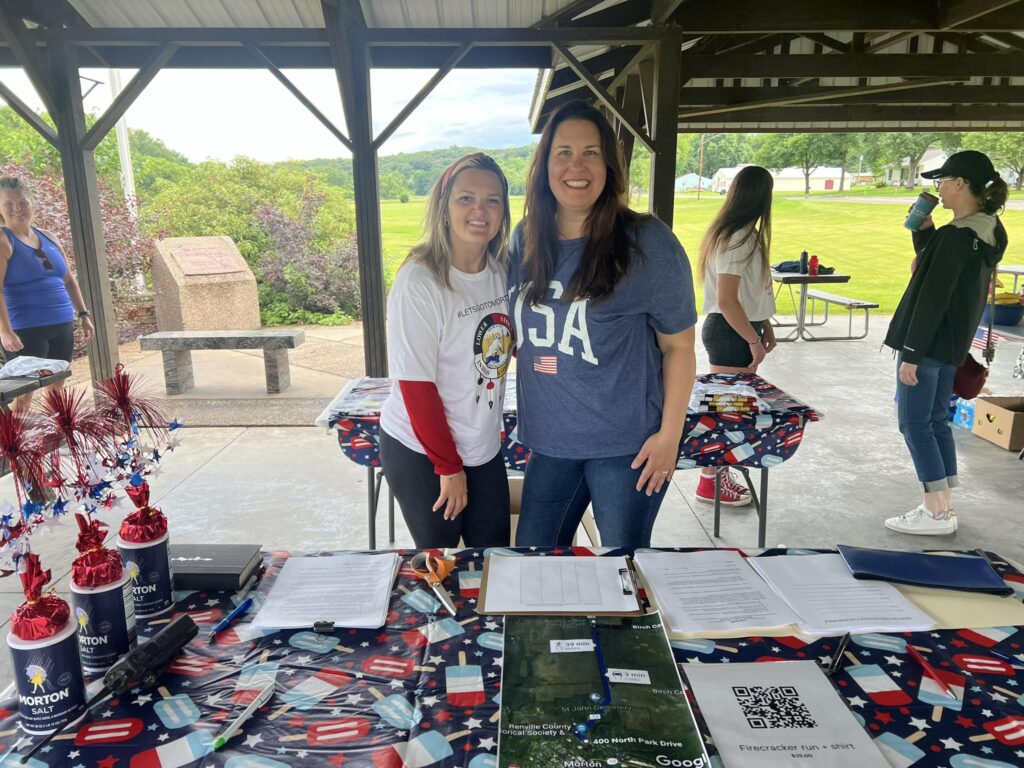 Brianna Goblirsch and Connie Bentson run check in for the Firecracker Run at Morton’s 4th of July Celebration.