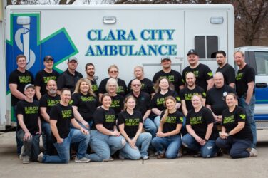 Clara City Ambulance Service operates with a crew of 24 volunteers, who are posed in front of the ambulance.