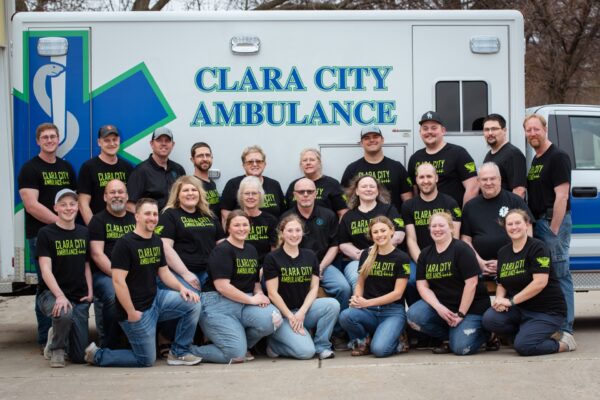 Clara City Ambulance Service operates with a crew of 24 volunteers, who are posed in front of the ambulance.