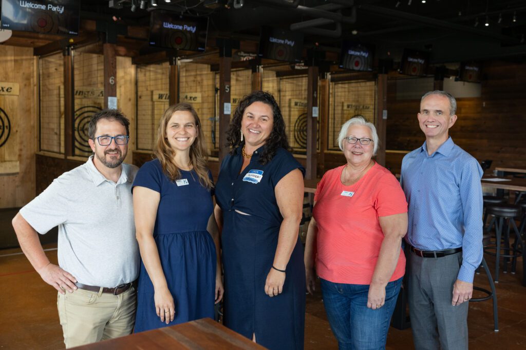 SWIF staff pose for a group photo at a Summer Social event.