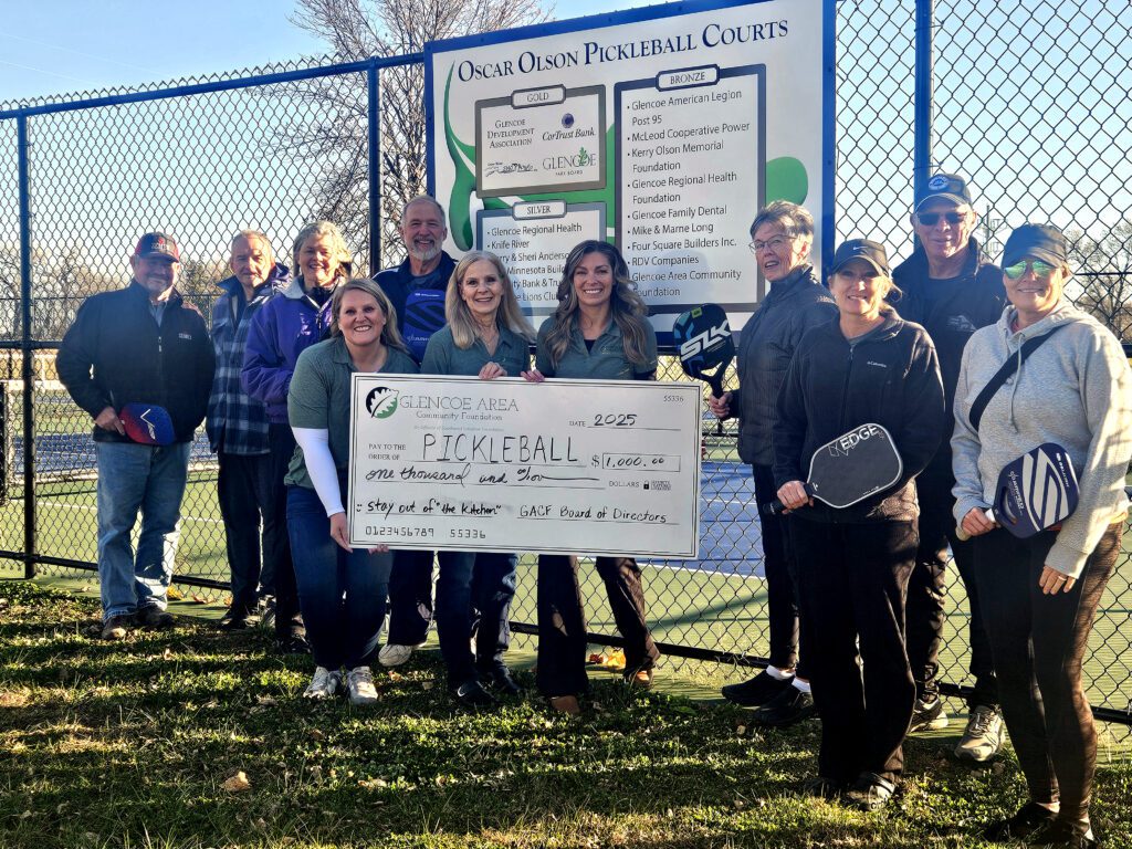 Glencoe Area Community Foundation Advisory Board Members present a check for the new pickleball courts.