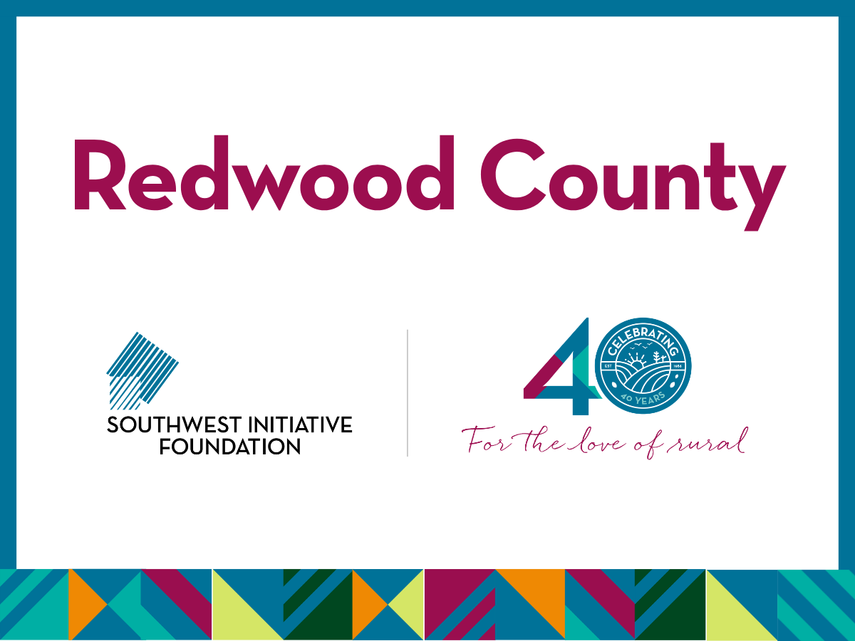 Redwood County sign with logos for Southwest Initiative Foundation and a 40th Celebration: For the love of rural symbol, bordered by a colorful geometric pattern at the bottom.