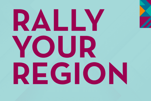 Large bold magenta text on a light blue background reads Rally Your Region Southwest Minnesota, with a colorful geometric pattern in the top right corner.